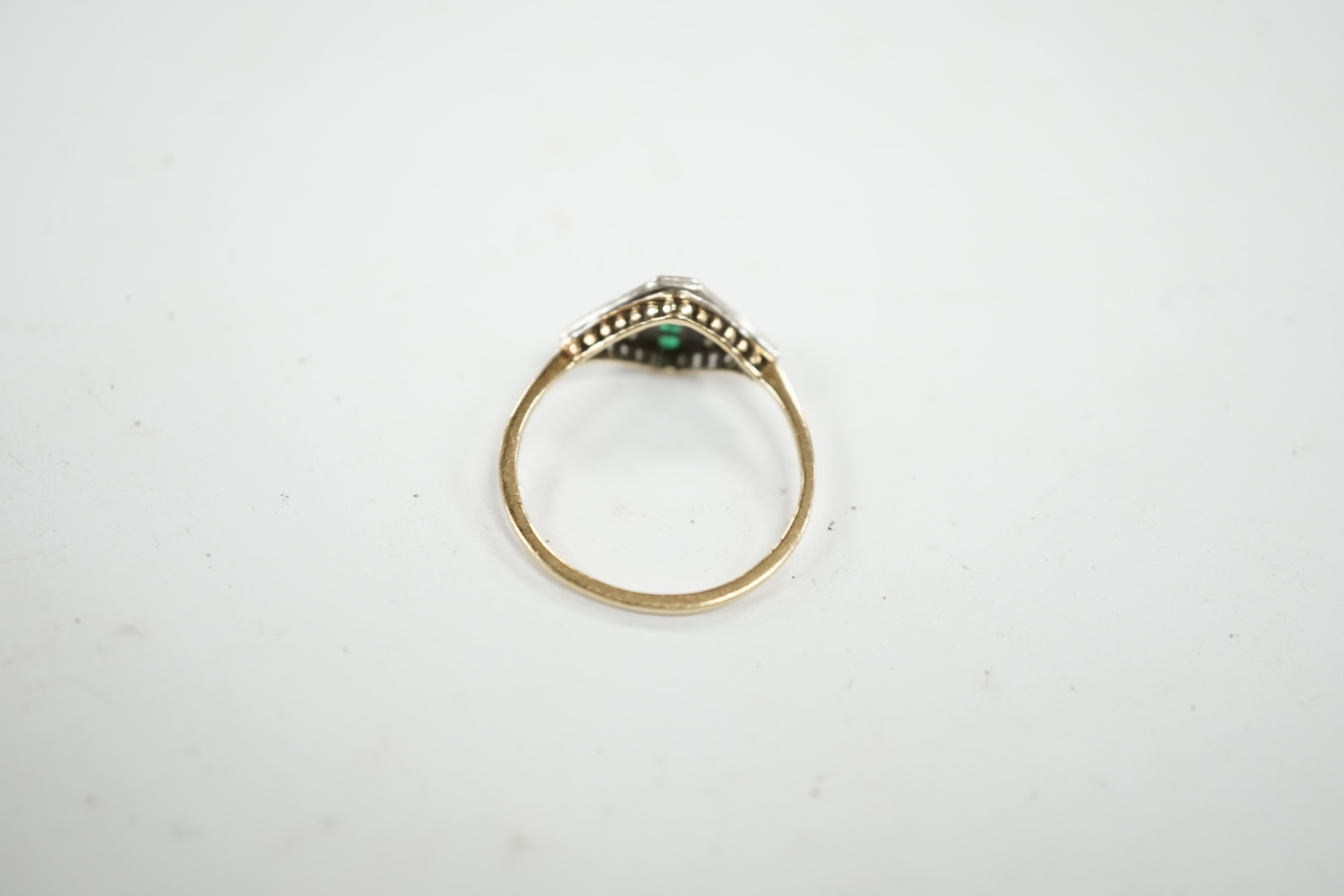 A small early 20th century 15ct, emerald and diamond cluster set ring, size P, gross weight 1.6 grams. Condition - fair